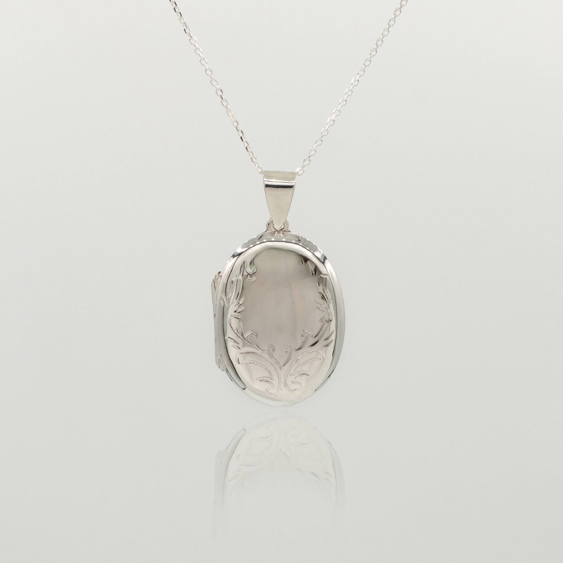 round oval large sterling silver locket with delicate design