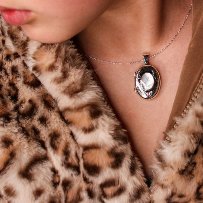 Model wearing Oval shaped embellished silver photo locket necklace with white mother of pearl inlay on Italian silver chain.