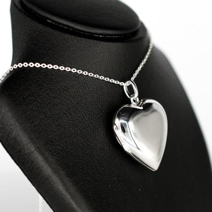 large heart-shaped silver photo locket necklace with a high mirror finish on a silver chain.