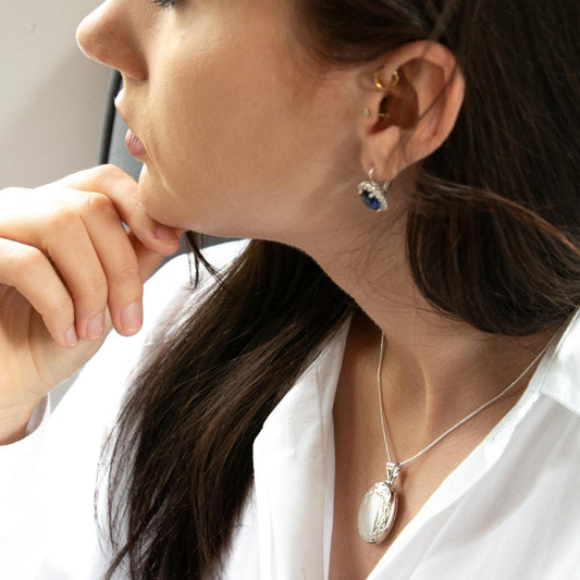 Model wearing white shirt and oval silver photo locket necklace on silver Italian Chain