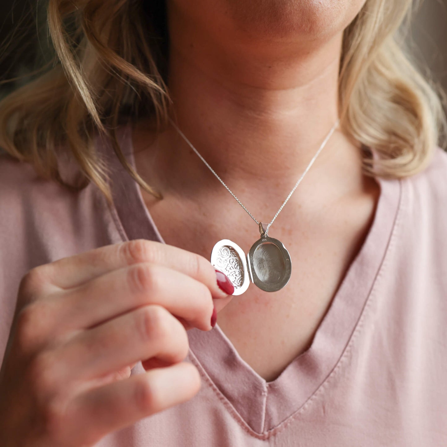 model holding open sterling silver photo locket