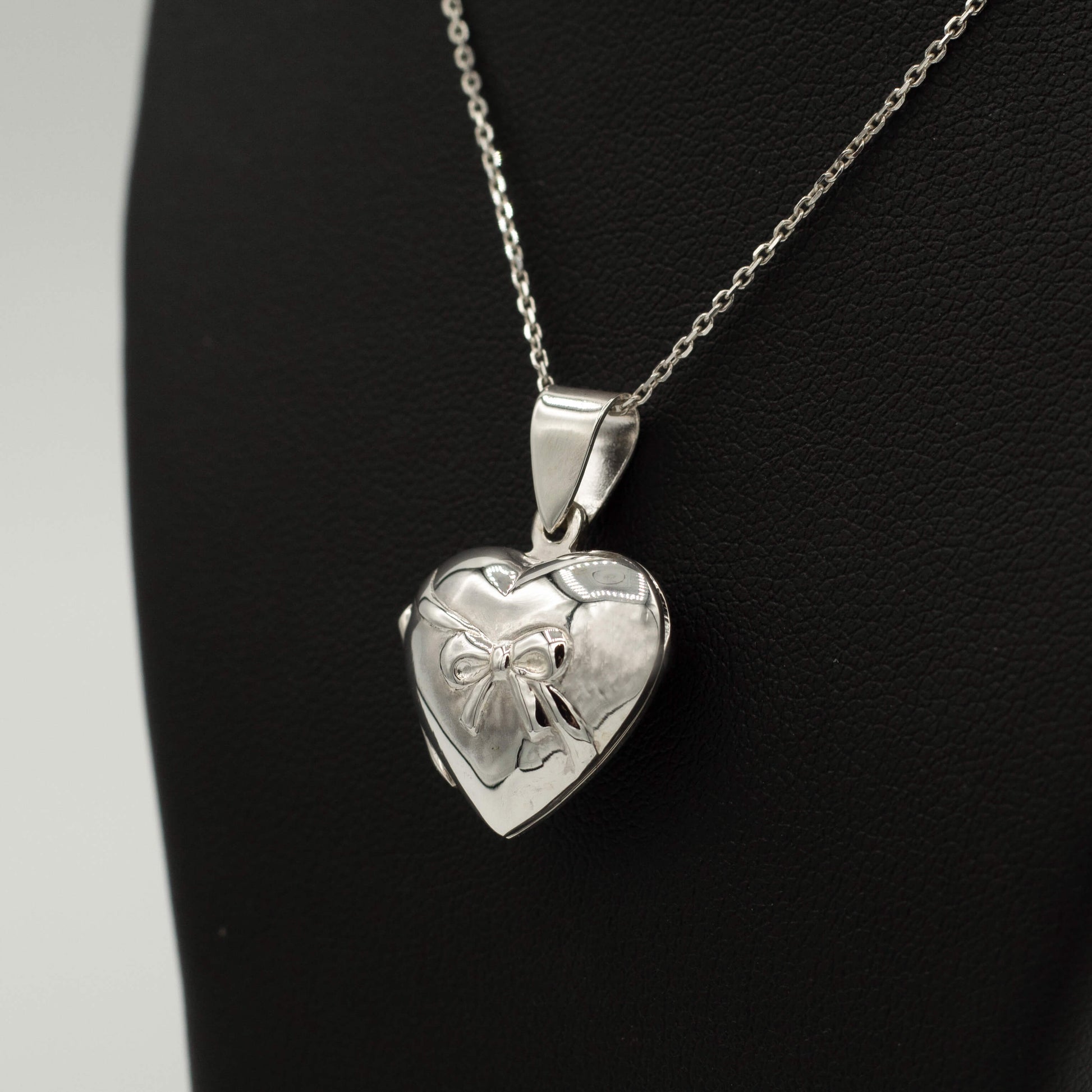 Side view of photo locket with bow