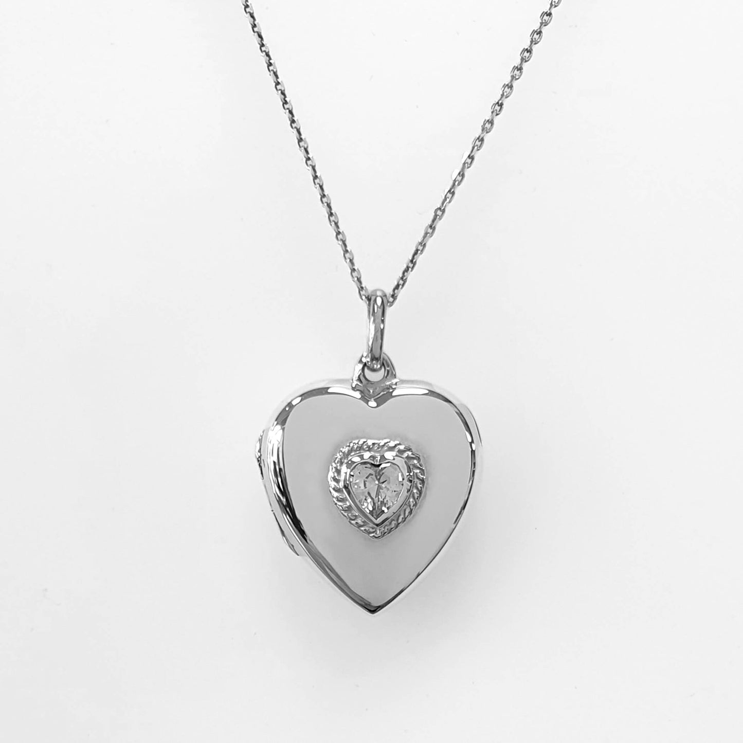 heart shaped photo locket with cubic zirconia on white background