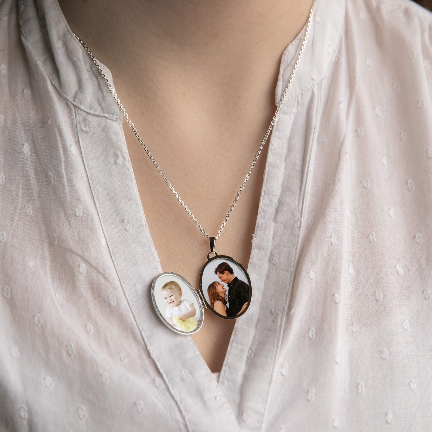 model wearing a sterling silver locket open showing photos inside