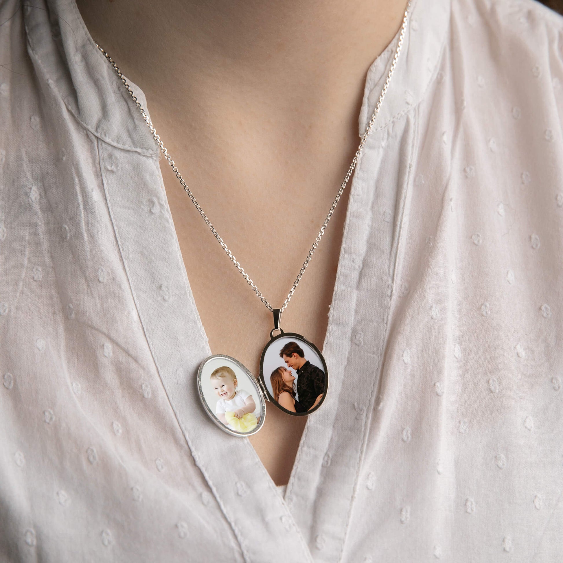 model wearing a sterling silver locket open showing photos inside