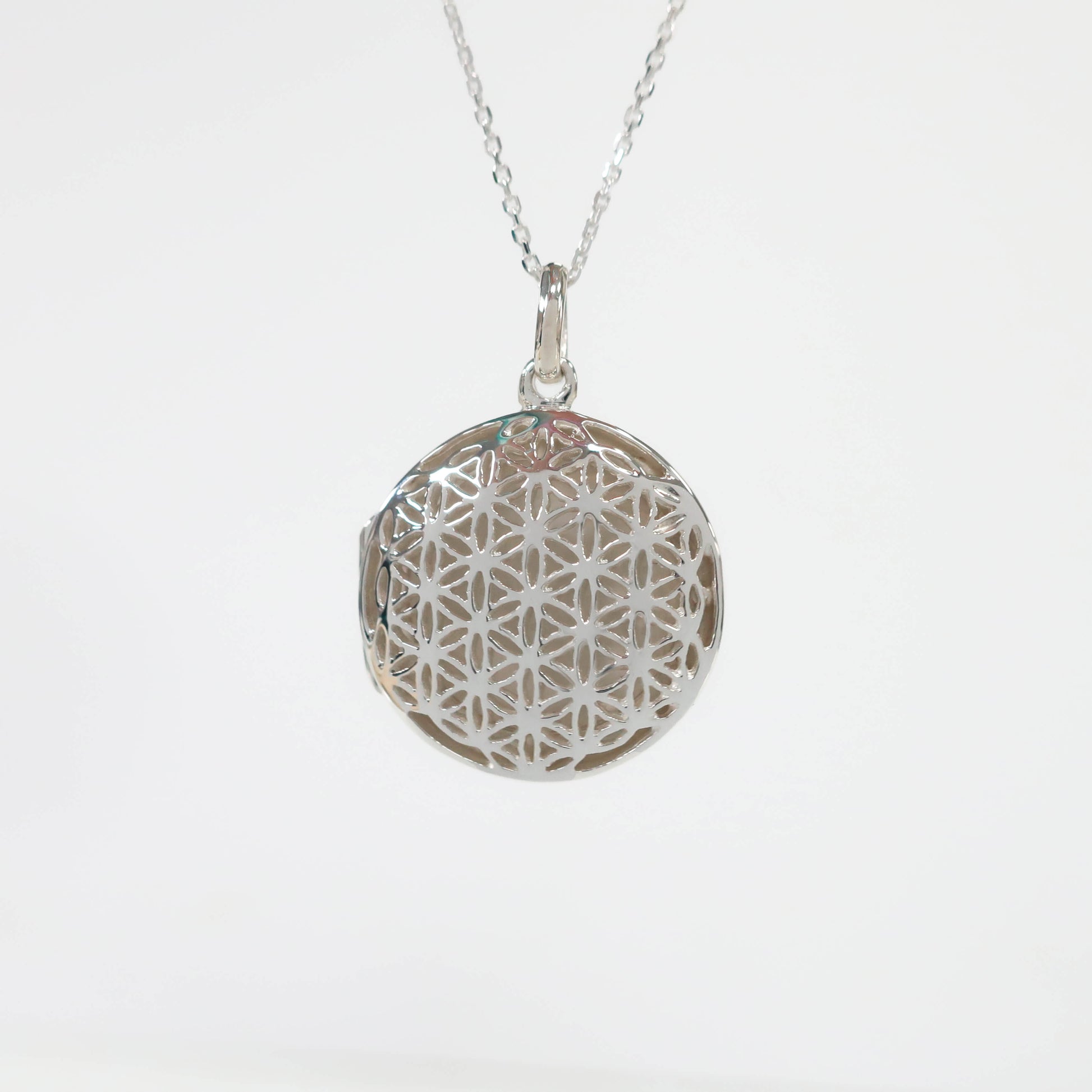 round silver geometric locket necklace on a white background