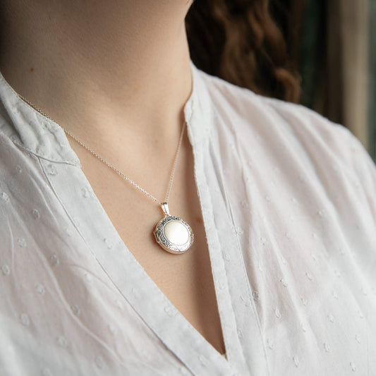 model wearing round photo locket
