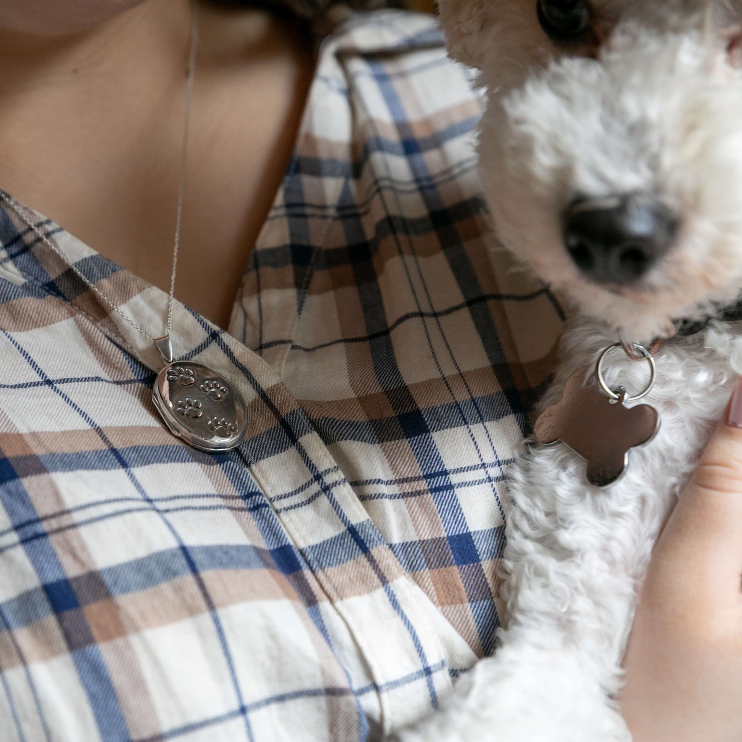 silver locket and white dog