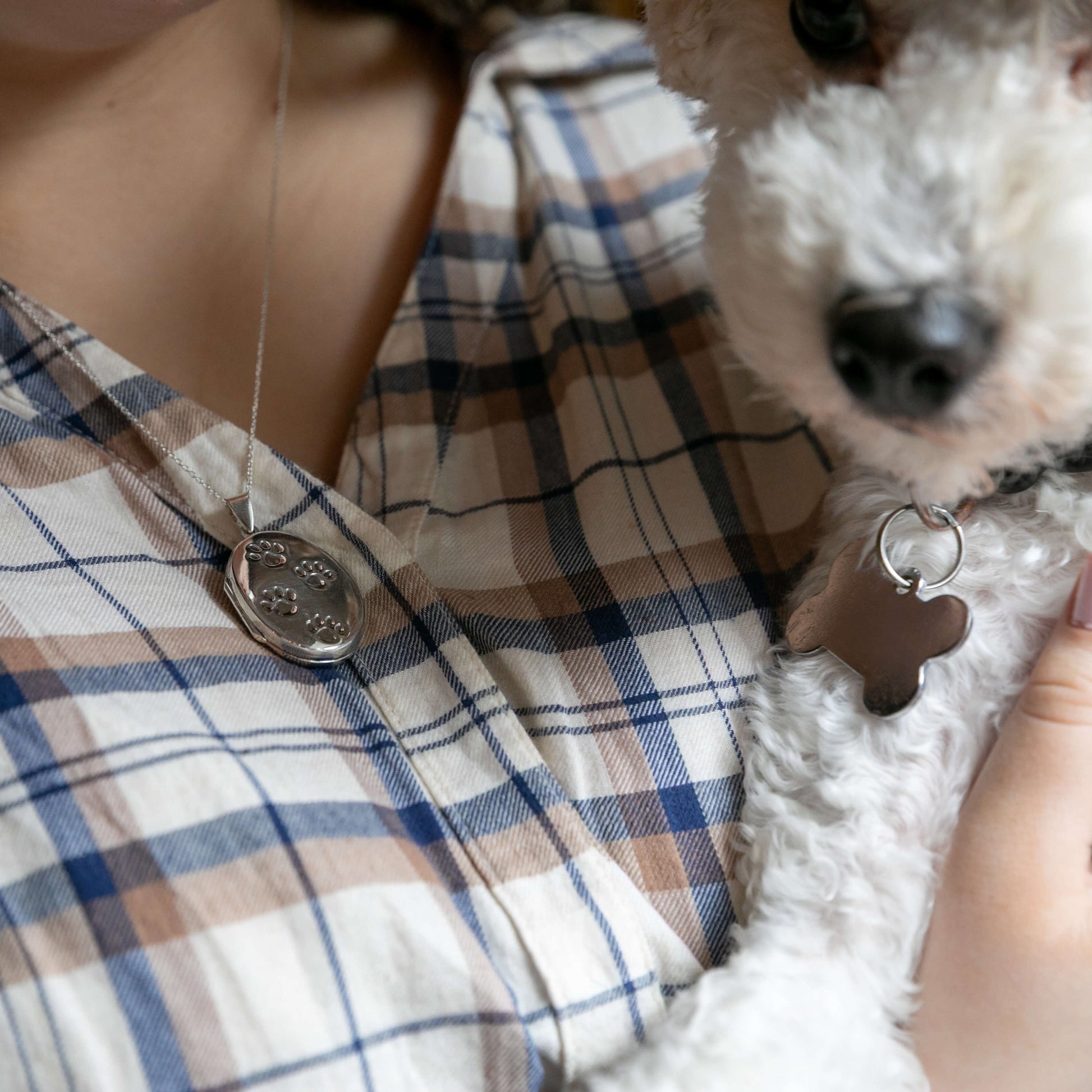silver locket and white dog