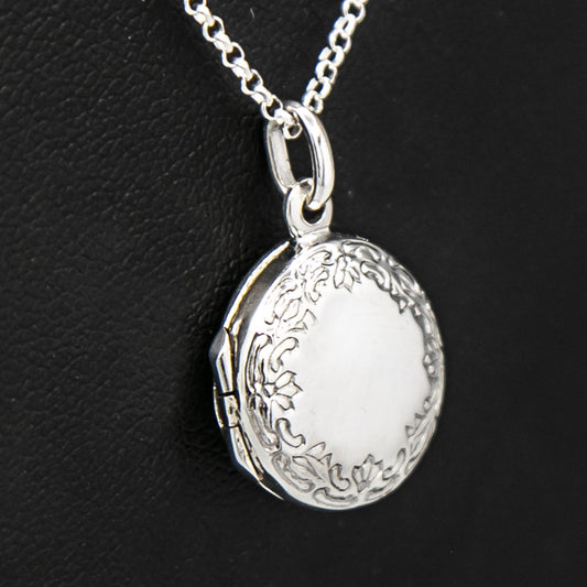 Close up view of round silver photo locket and silver chain