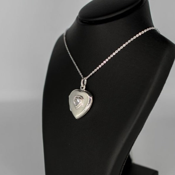 Heart-shaped photo locket necklace with cubic zirconia inset on a silver chain.
