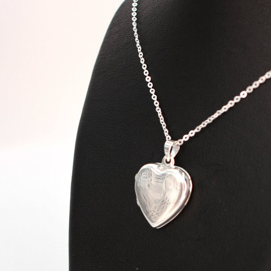 Heart-shaped photo locket necklace with high mirror finish on a silver chain.