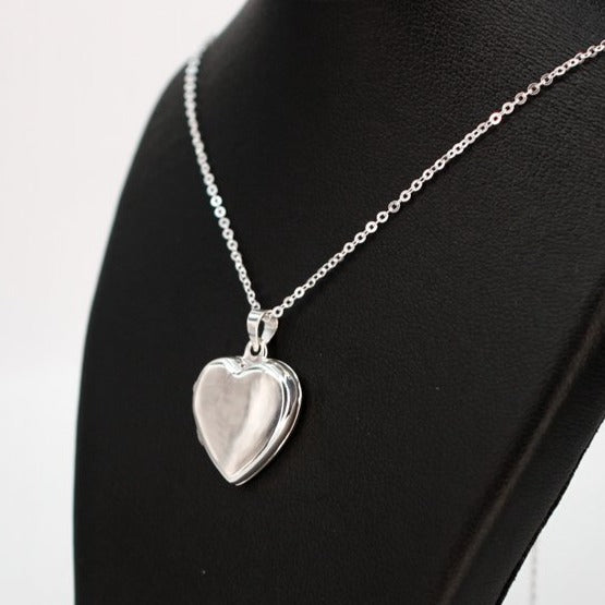 Contemporary locket necklace with high mirror finish on a silver chain.