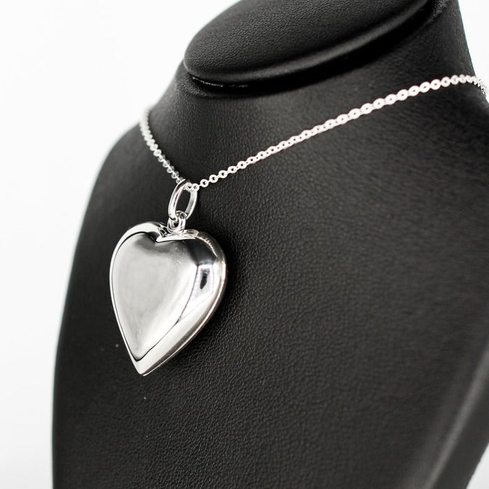 large heart locket necklace with a high mirror finish on a silver chain.