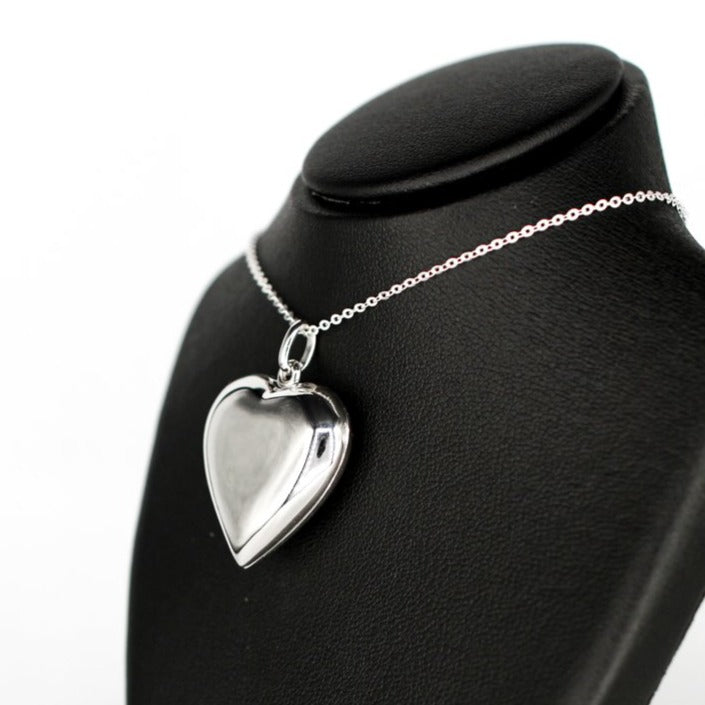 large heart-shaped silver photo locket necklace with a high mirror finish on a silver chain.