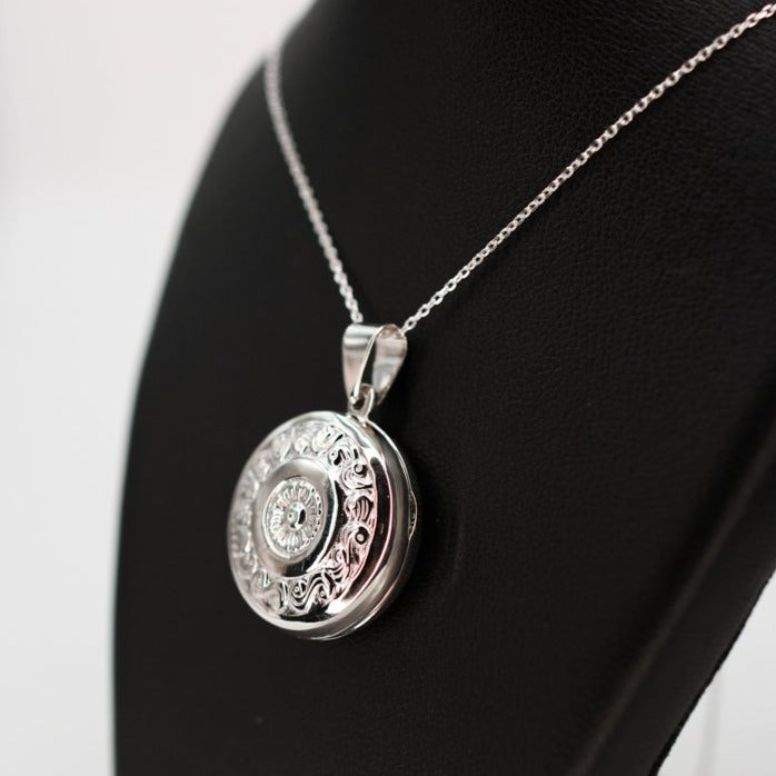 Large silver photo locket pendant on a silver chain.