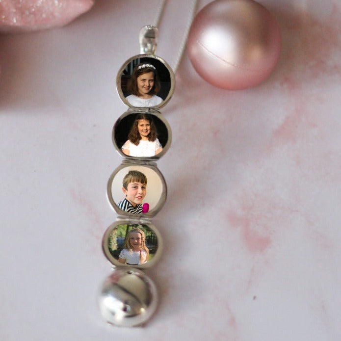 multi photo locket showing pictures of 4 children with Christmas baubles and Christmas Tree