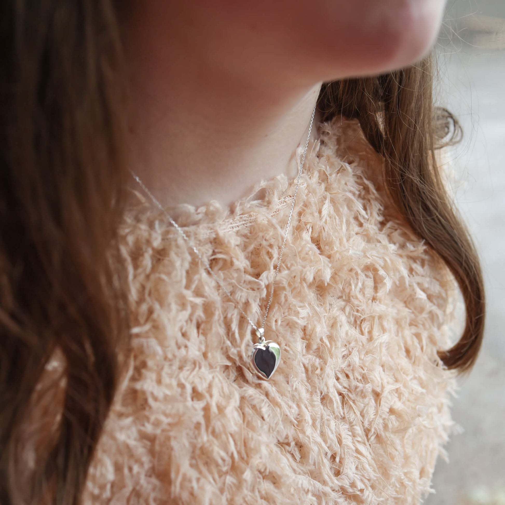 modern locket necklace worn by young model